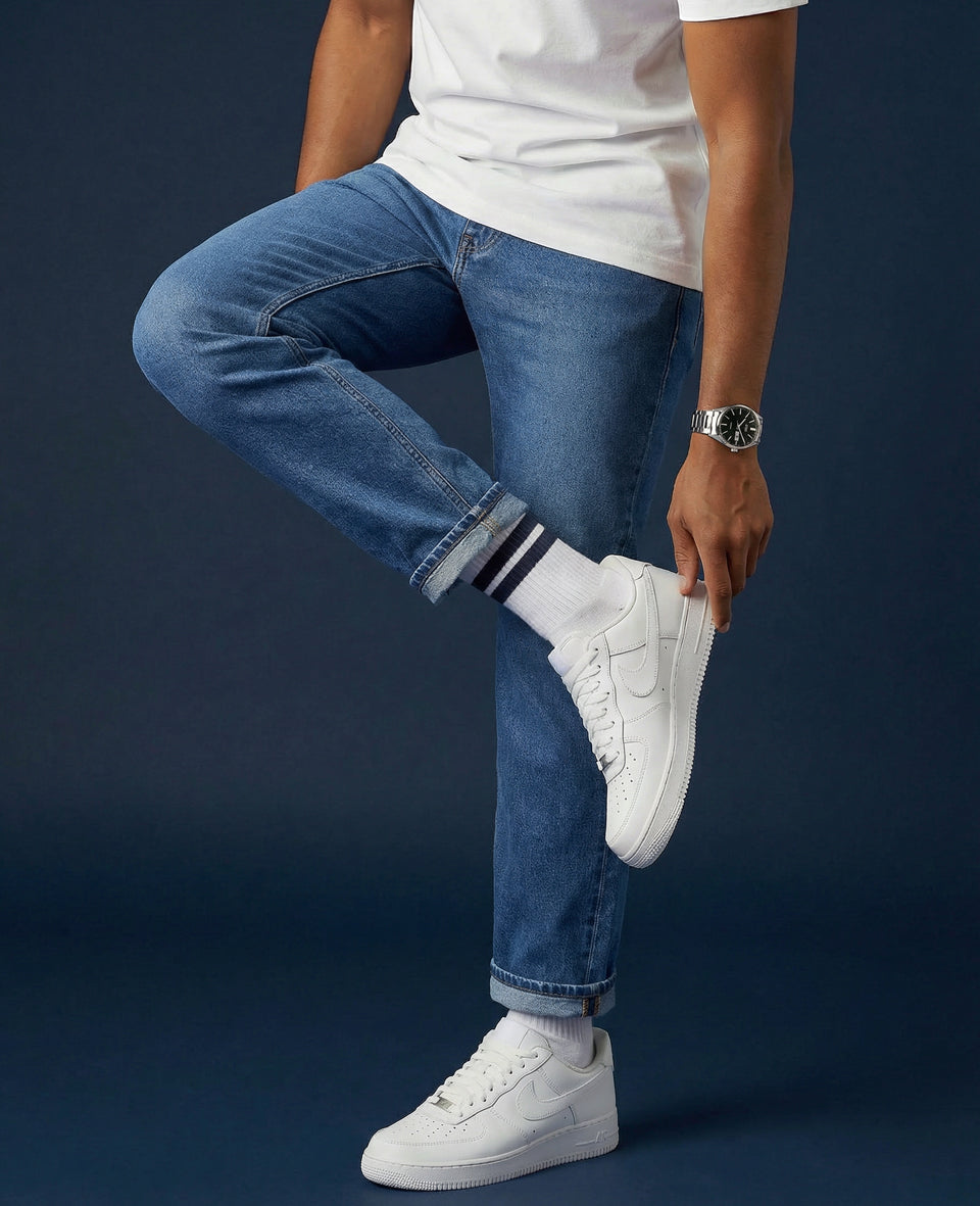 White crew socks paired with white leather low-top sneakers — tonal styling
