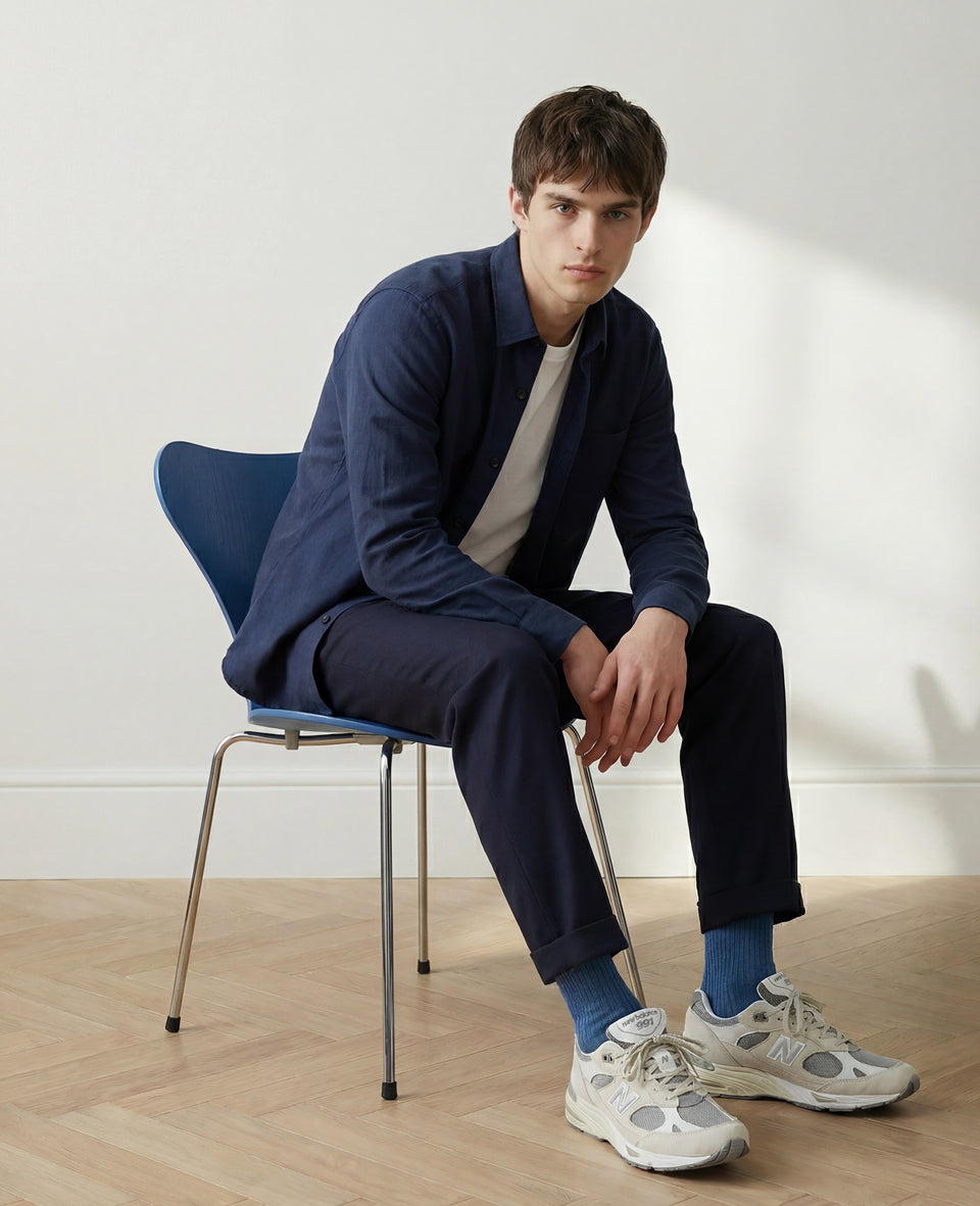 Premium blue fine rib socks styled with navy trousers and white sneakers – modern Scandinavian menswear