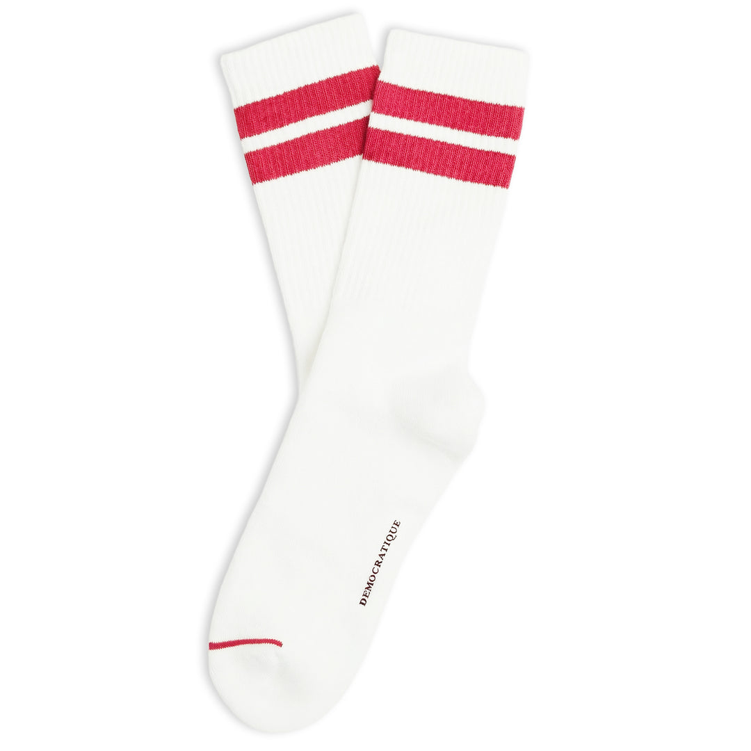 A pair of white crew socks with two red stripes near the cuff and a small red stripe on the toe, shown on a plain white background. The brand name Democ ratique Socks